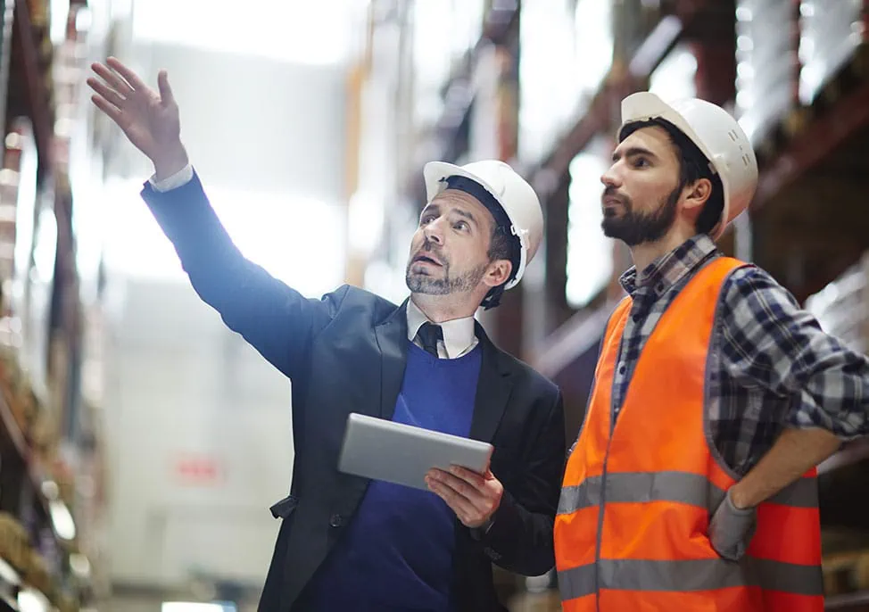 Manager reviewing with warehouse employee