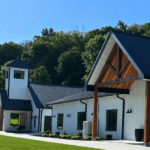 Exterior of the Romaine Valley wedding chapel and event building with landscaped lawn
