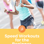 black female runner smiling on track with other runners