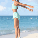 female runner jumping on beach