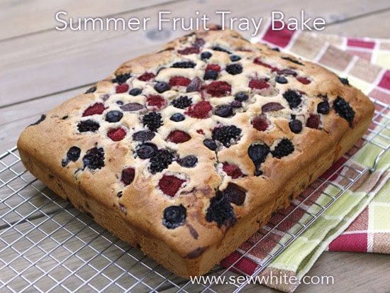 golden cake studded with summer berries summer fruit traybake