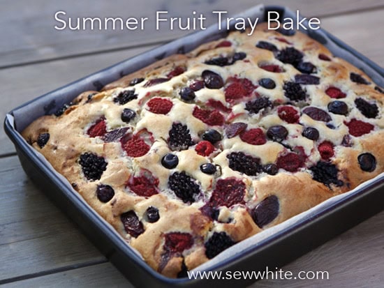 freshly cooked golden brown Summer Fruit Traybake still in the tin