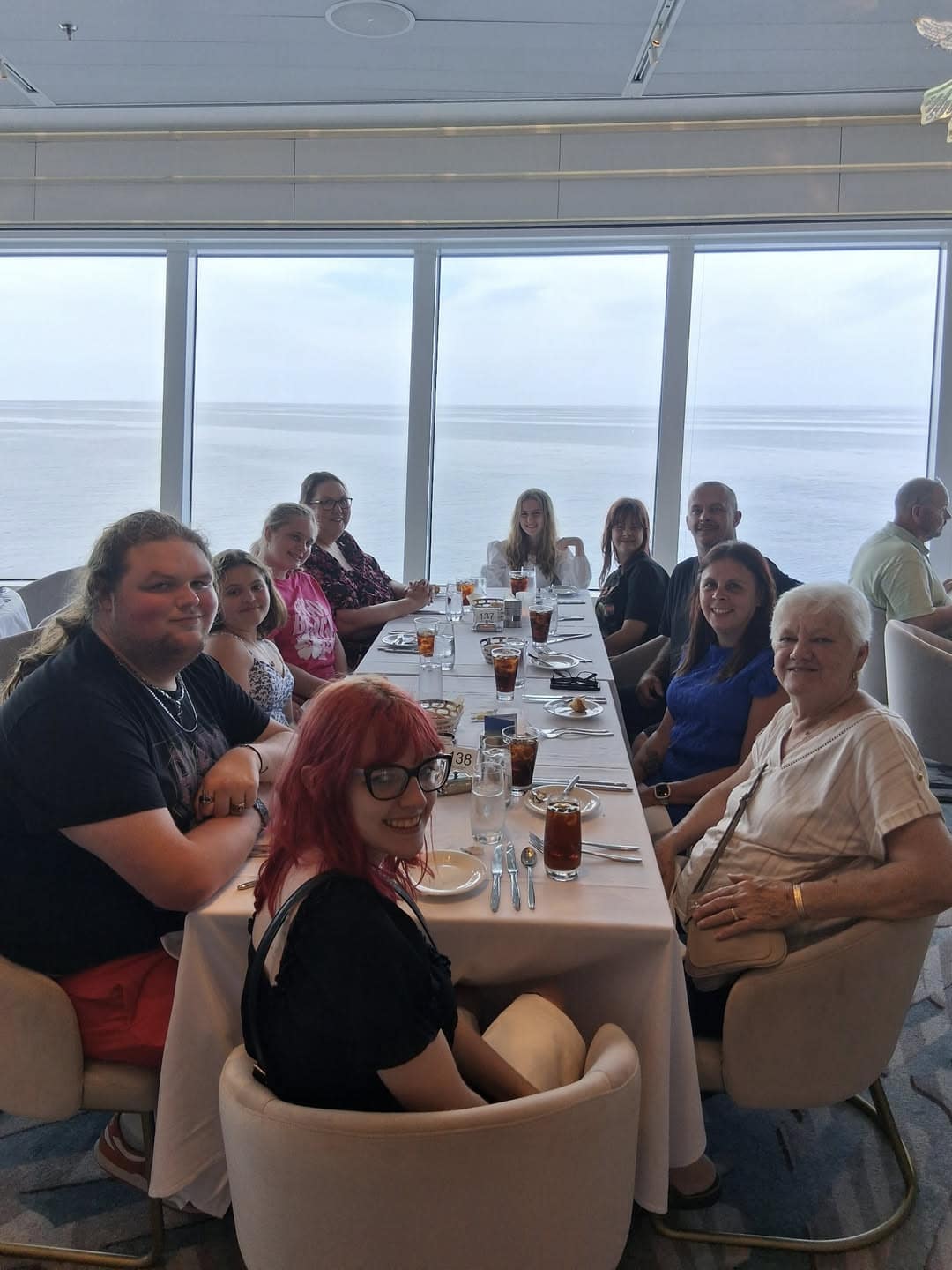 Spotlight families gathered around a table on a past cruise