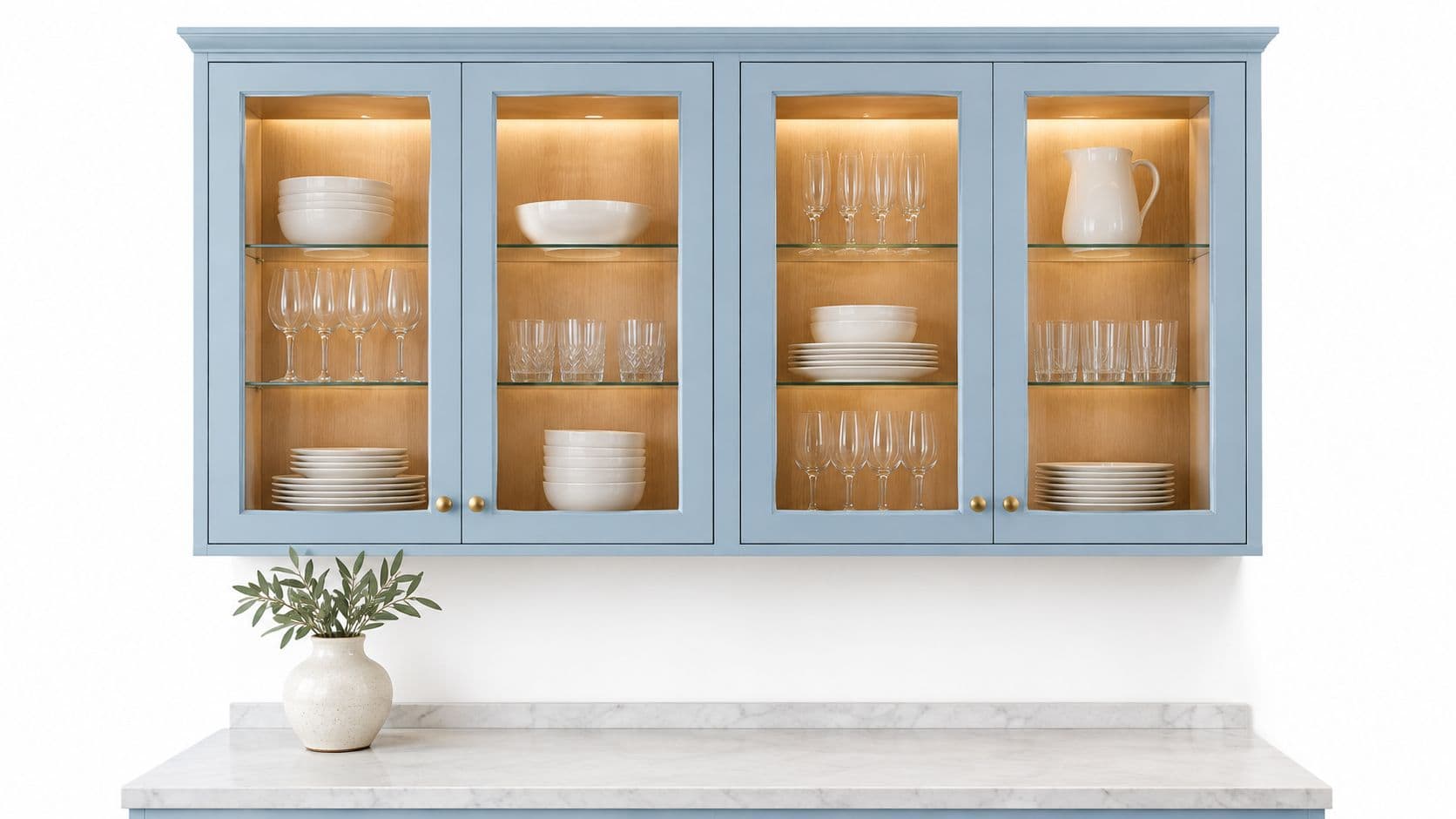 A modern light blue kitchen cabinet with glass doors mounted above a white marble countertop.
