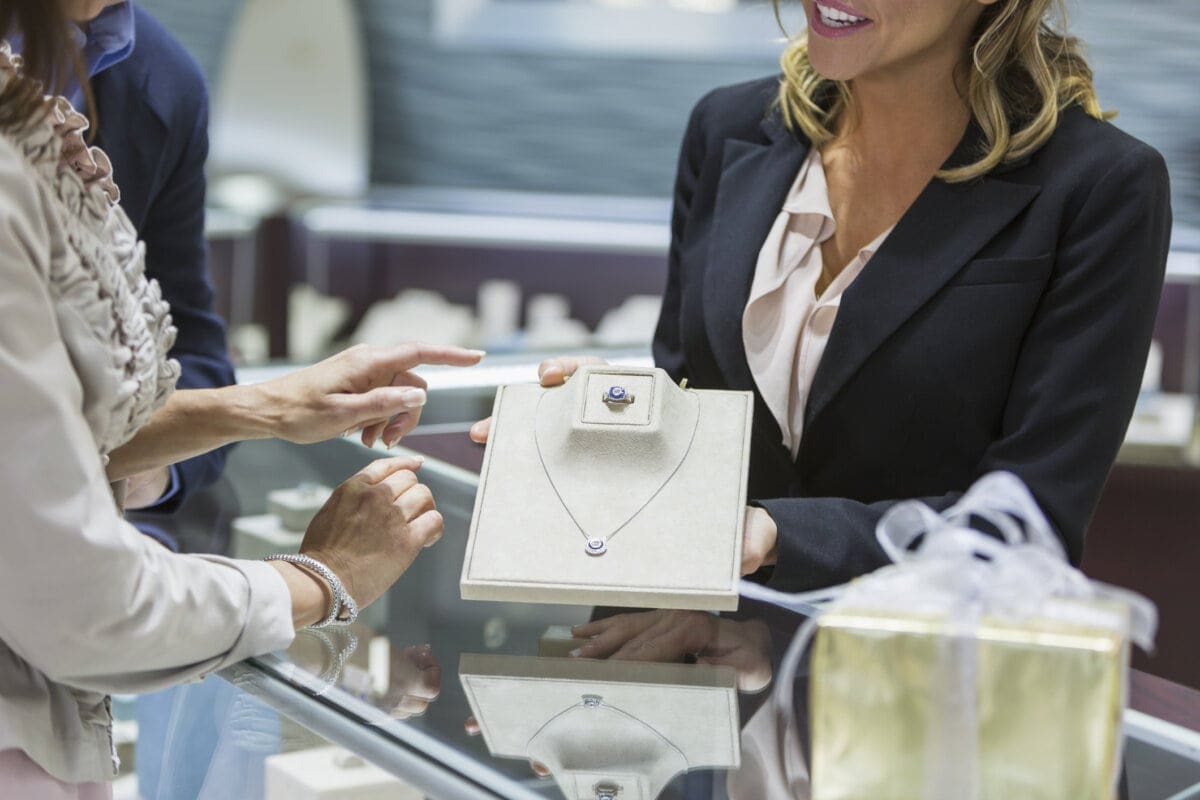 Saleswoman helping a couple in a jewelry store