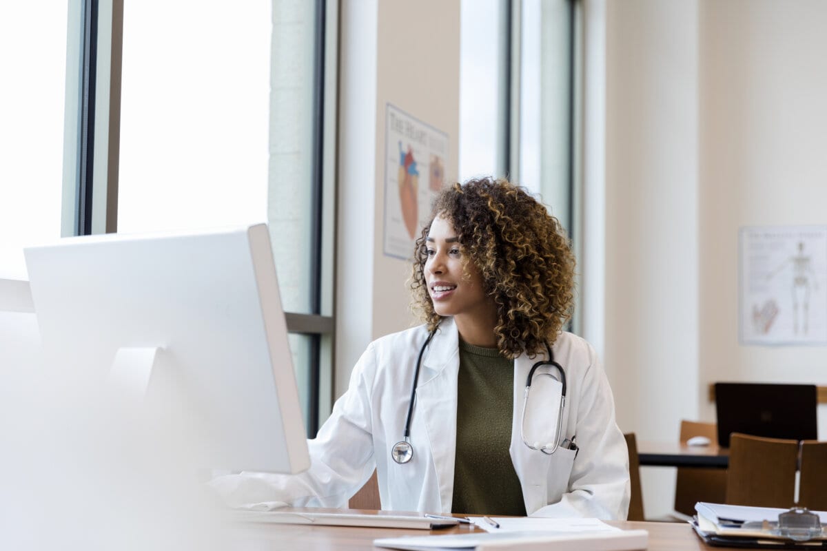 Female doctor reviews her patient's records