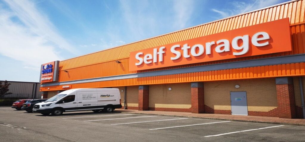 A storage warehouse with van in front