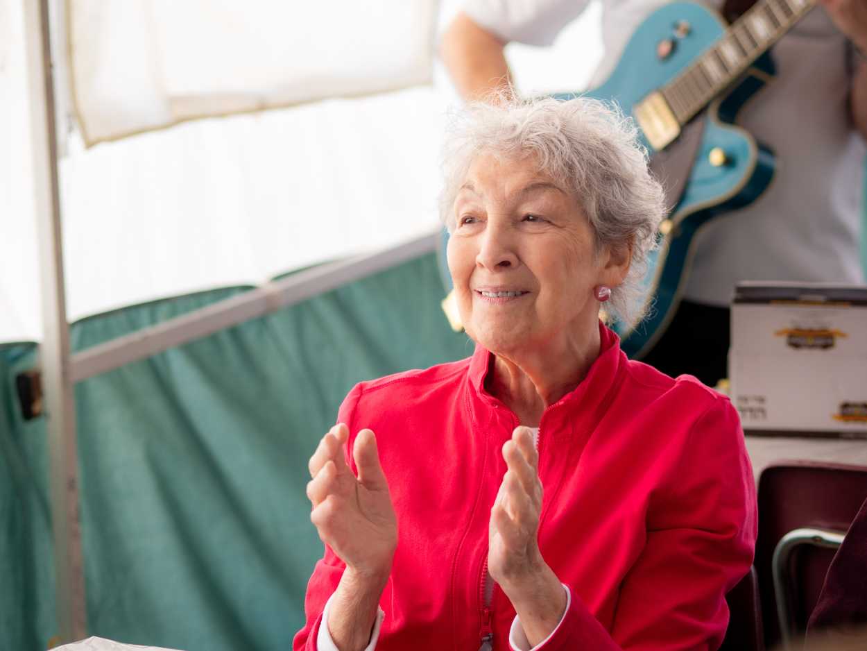 Resident participating in an intergenerational music program at Two Neptune Drive.