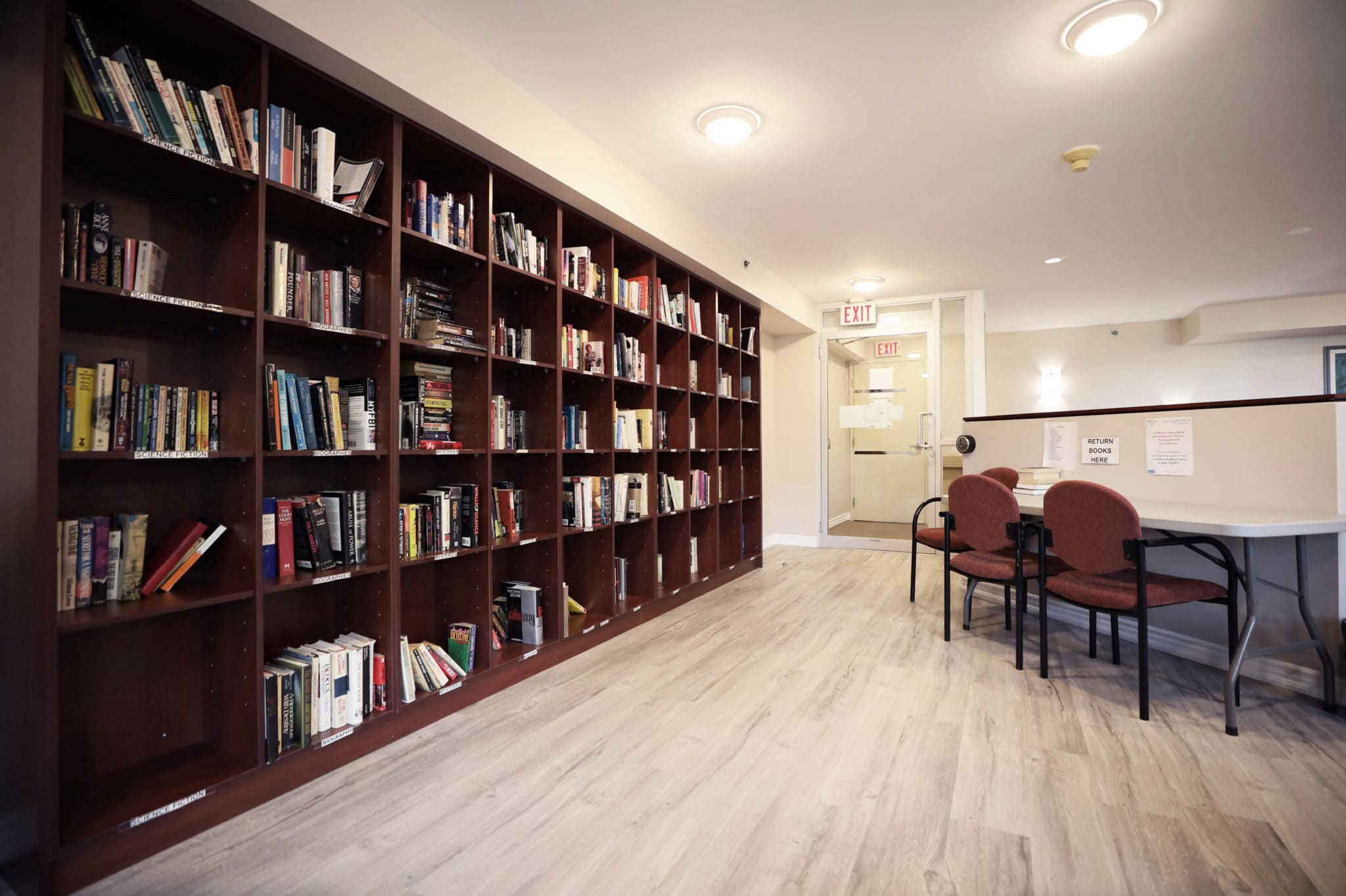 Library with bookshelves and seating at Two Neptune Drive.