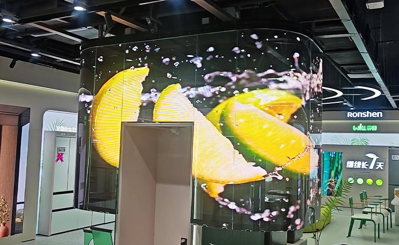 Crystal film transparent LED screen applied directly on glass windows displaying vibrant product visuals in a retail environment