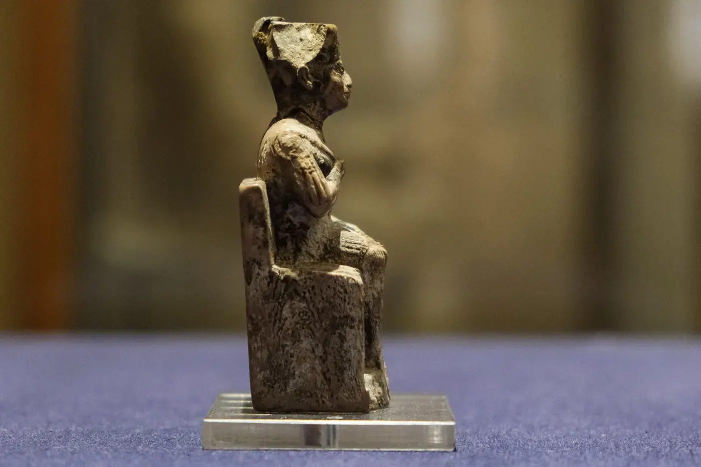 Ancient Egyptian ivory statuette shown from the side