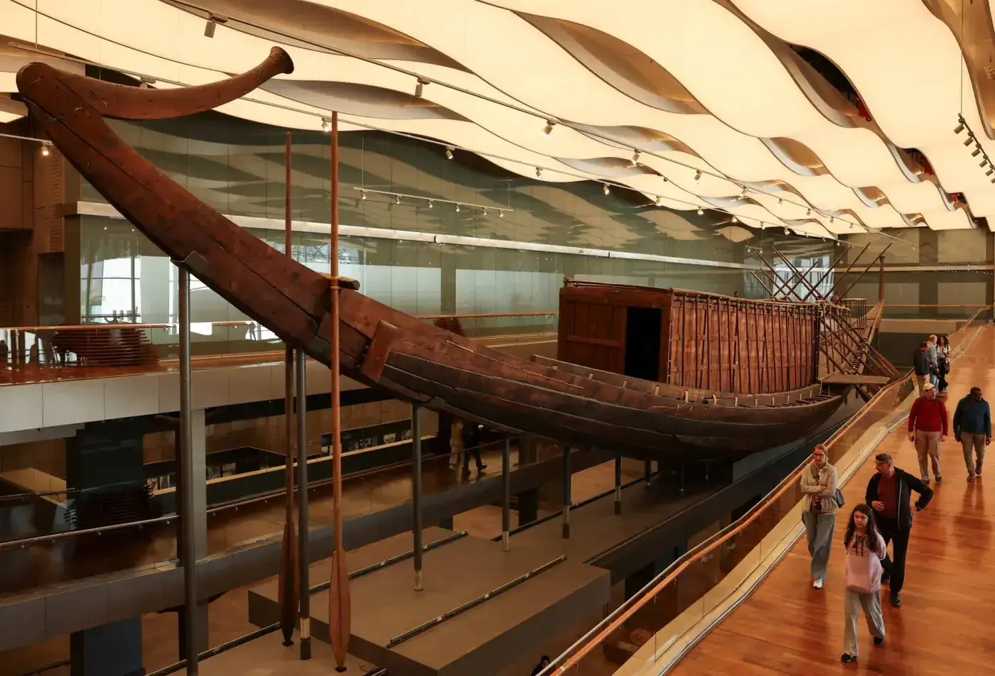Ancient wooden royal boat displayed inside a museum