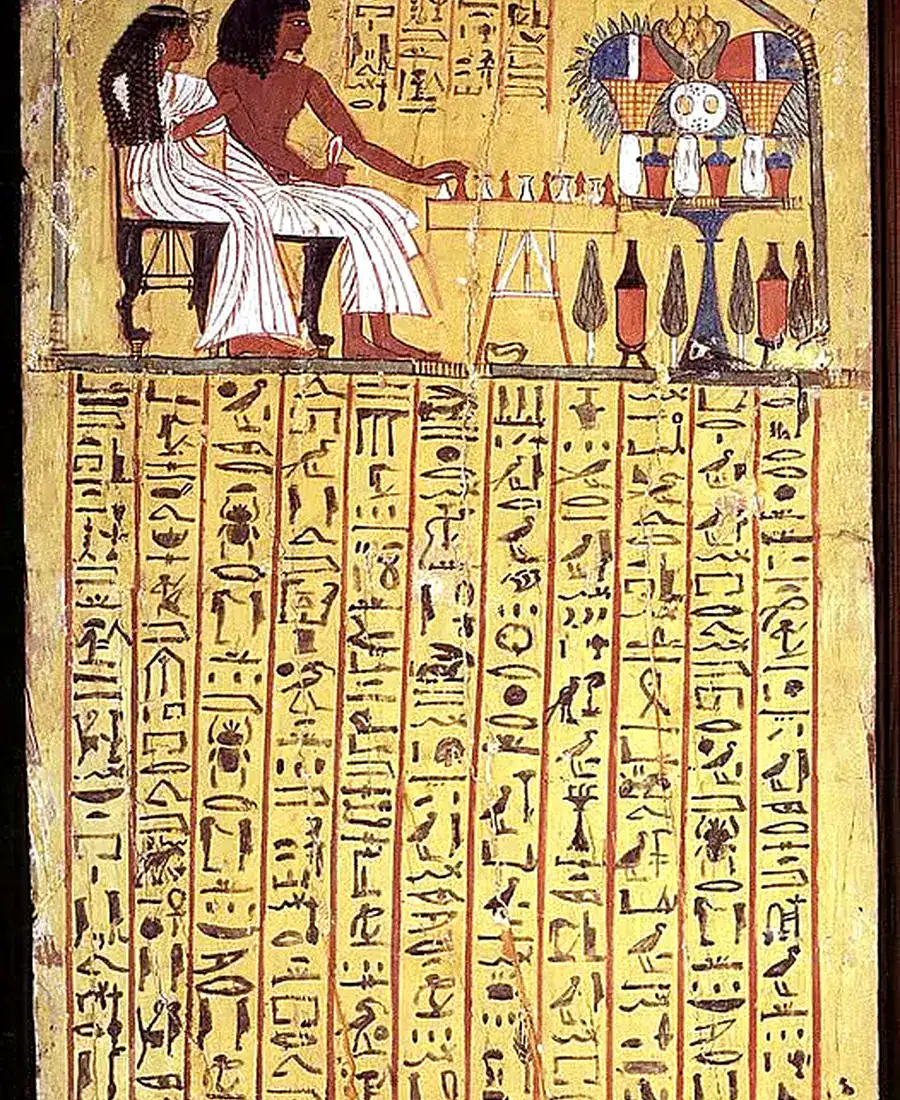 Painted funerary stela showing a seated couple and offerings