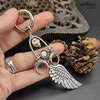 The sorcerer, large earring with a skull, moons and large angel wing