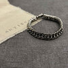 Silver chain bracelet on grey surface