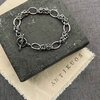 Silver chain bracelet with toggle clasp on slate.
