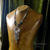 Silver pendant necklace on wooden mannequin