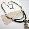 Handcrafted necklace with turquoise beads and pendant.