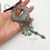Hand holding silver heart pendant necklace