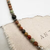 Colourful stone bead bracelet on fabric background.
