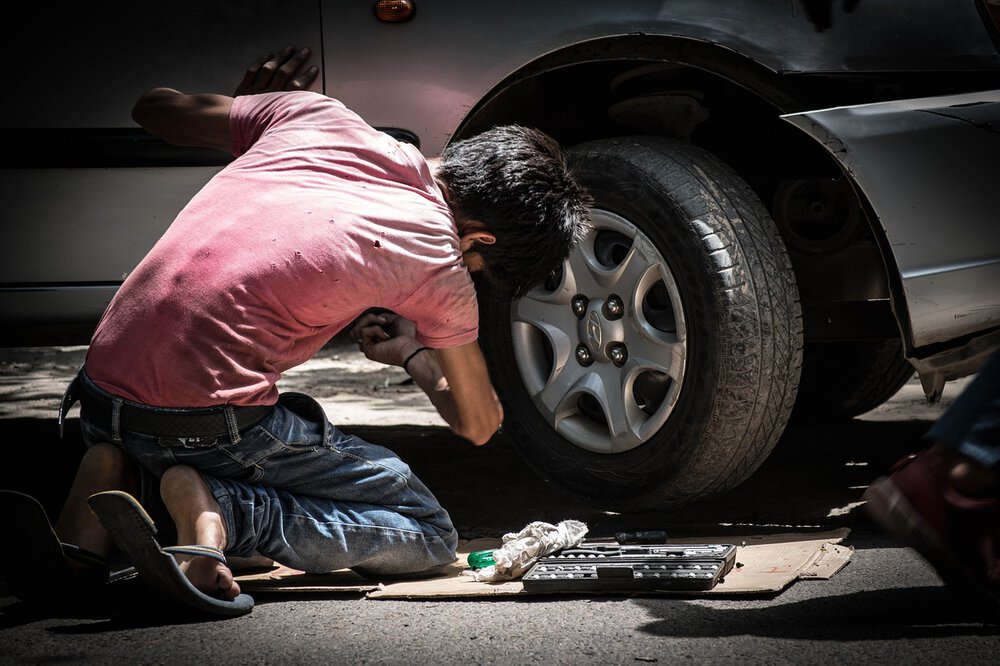 kid fixing a car, car insurance, meeting your insurance needs