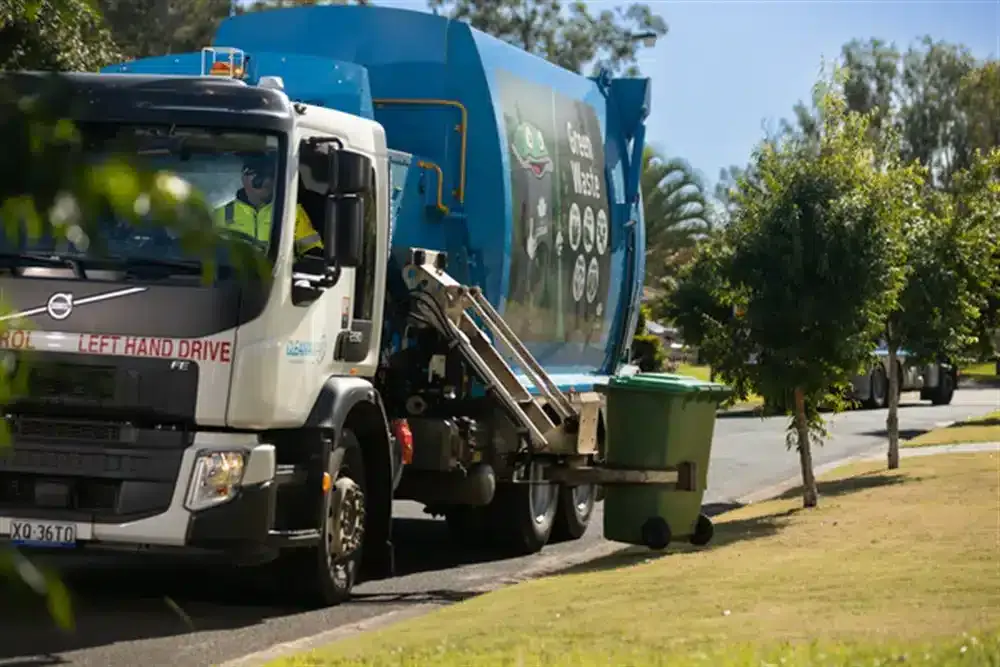 A logan city council (QLD) bin truck picking up a curbside bin