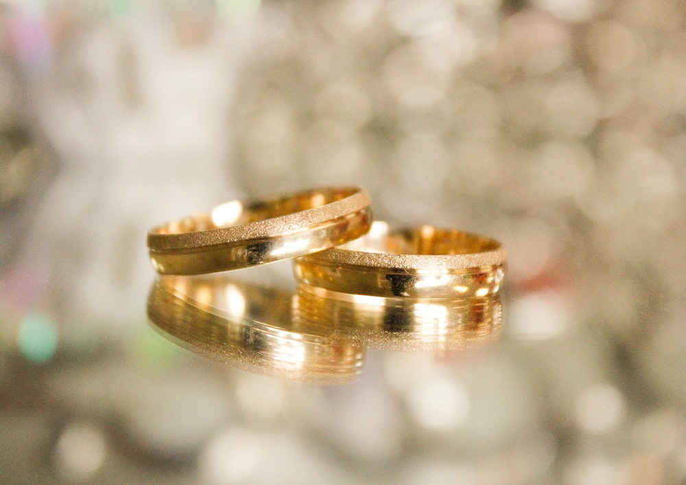 two gold colored rings in selective focus photography