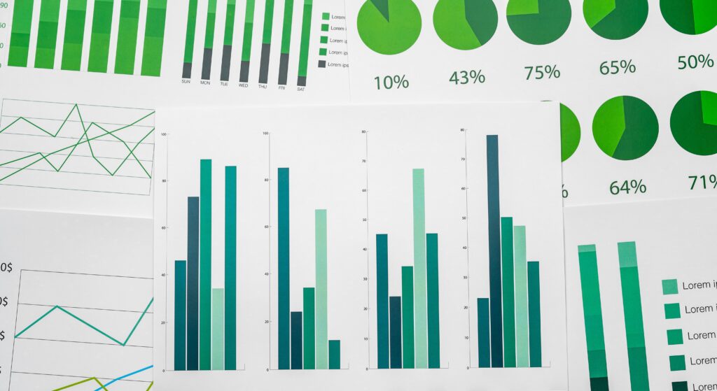 article banner featuring a bunch of paperes with green colored charts indicating performance