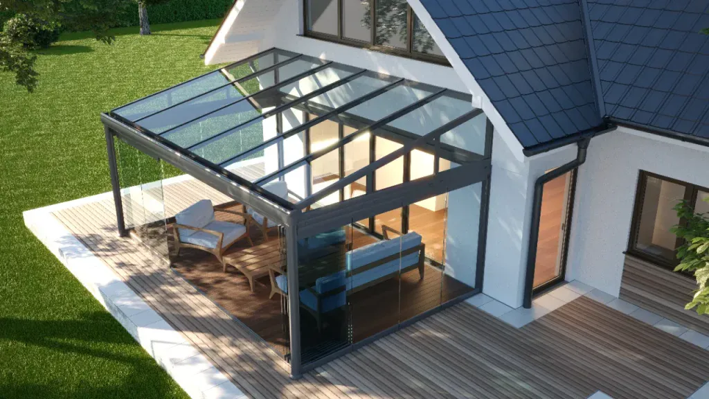 Modern orangery with full glass roof and anthracite aluminium frame extending into garden with contemporary furniture