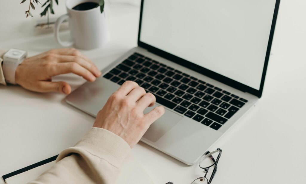 banner for article Digital Marketing Strategies for Healthcare Brands on LinkedIn featuring a person typing on a laptop