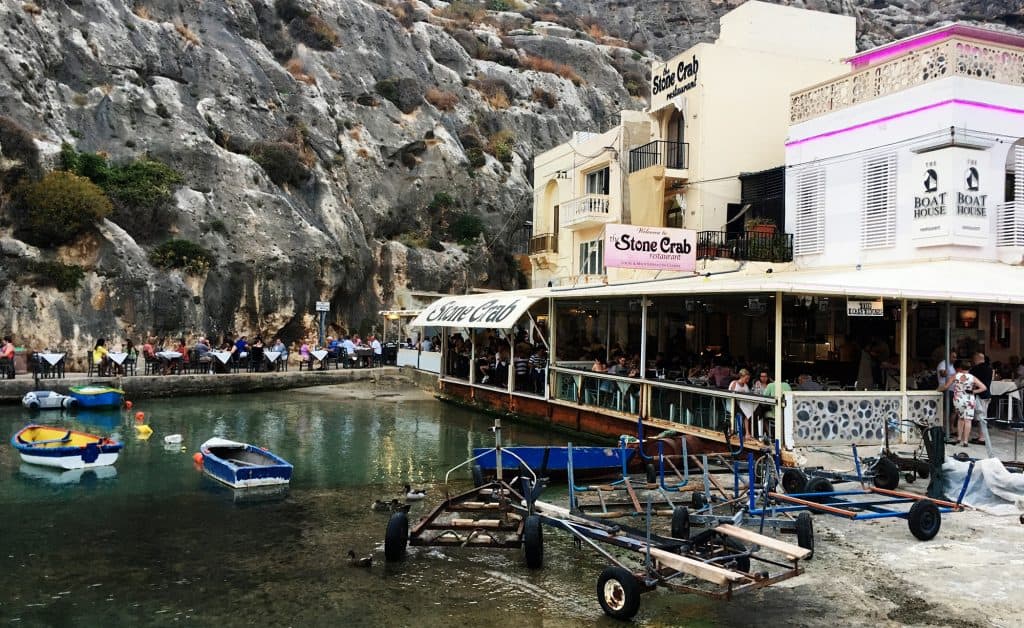 Ta Karolina is the restaurant at the end near the rocks wall, if you book in advance you can get one of those tables where the water almst touches your feet.