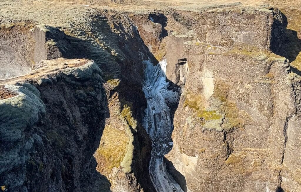 The frozen waterfall at Fjaðrárgljúfur Canyon in Iceland 