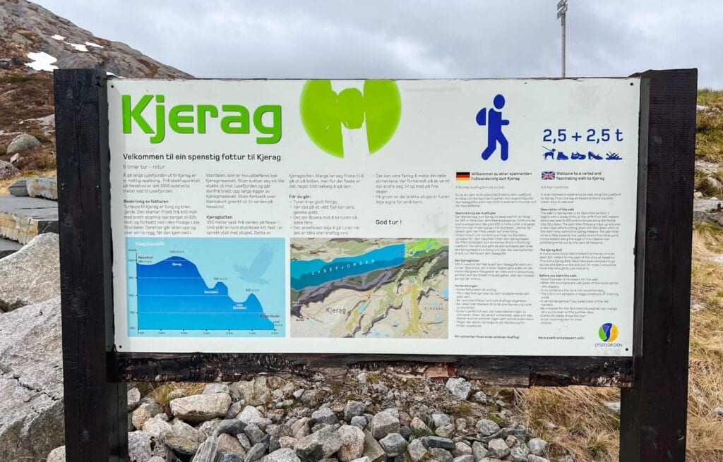 Information board about Kjerag with trail details, elevation graph, and map in Norwegian and English.