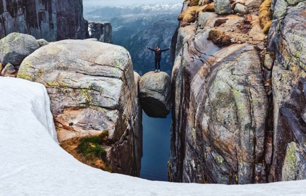 Standing on top of Kjerag - one of the most terrifying hikes near Stavanger
