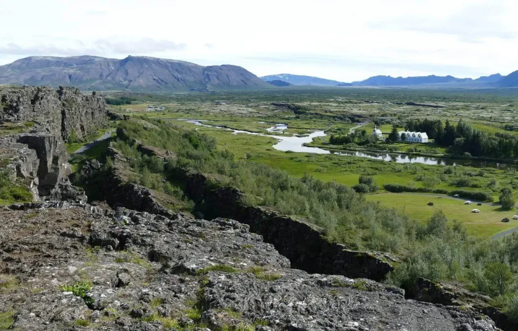 A beautiful shot of Thingvellir National park in summer from above, with the mountains in the background and the river running through it and lots of green trees