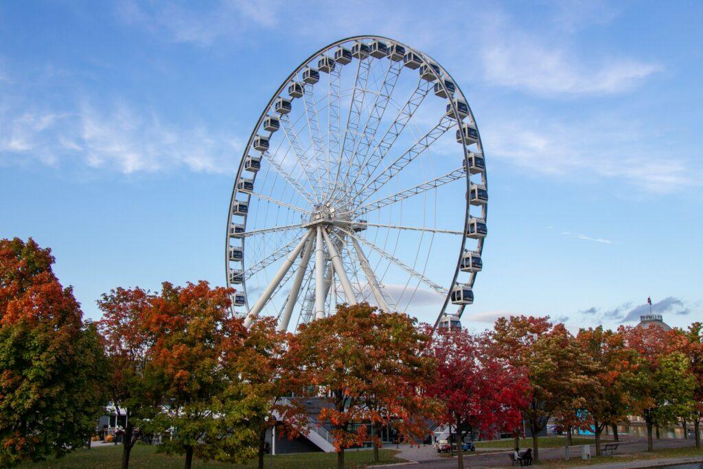 Carnival rides and festival atmosphere at Old Port of Montreal Fall Fair with crowds and illuminated attractions