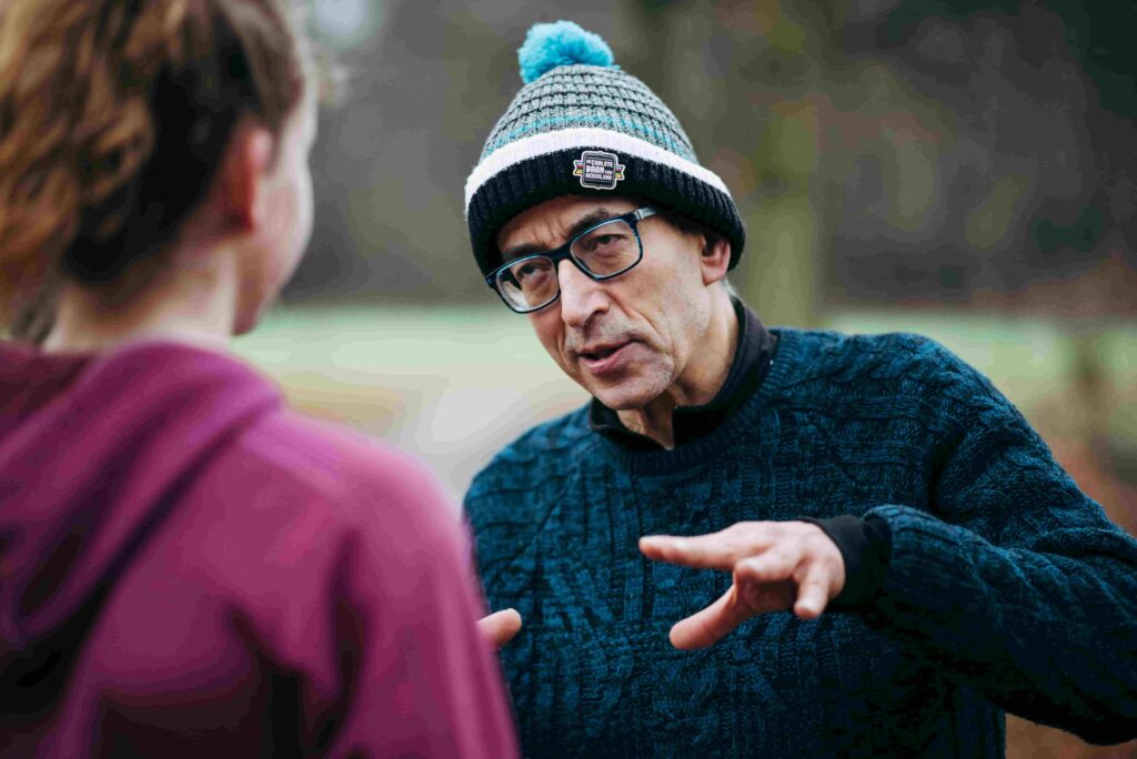 A photo of a man talking to a woman and gesticulating 