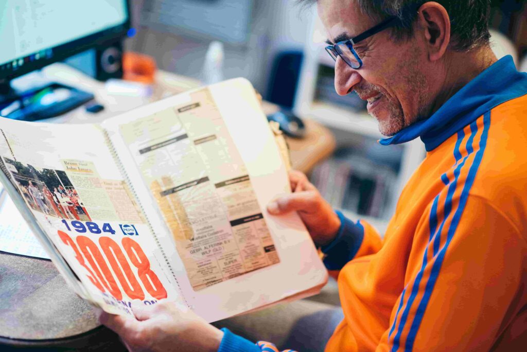 A photo of a man looking through an A-Z