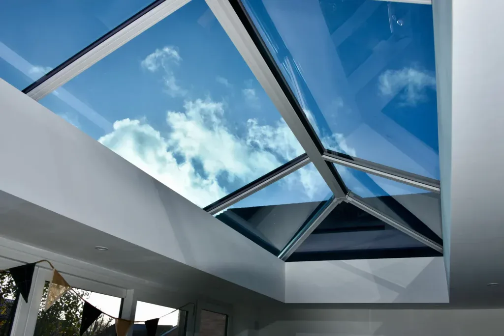 Close-up of an orangery roof lantern with blue sky visible through black and white glazing bars.