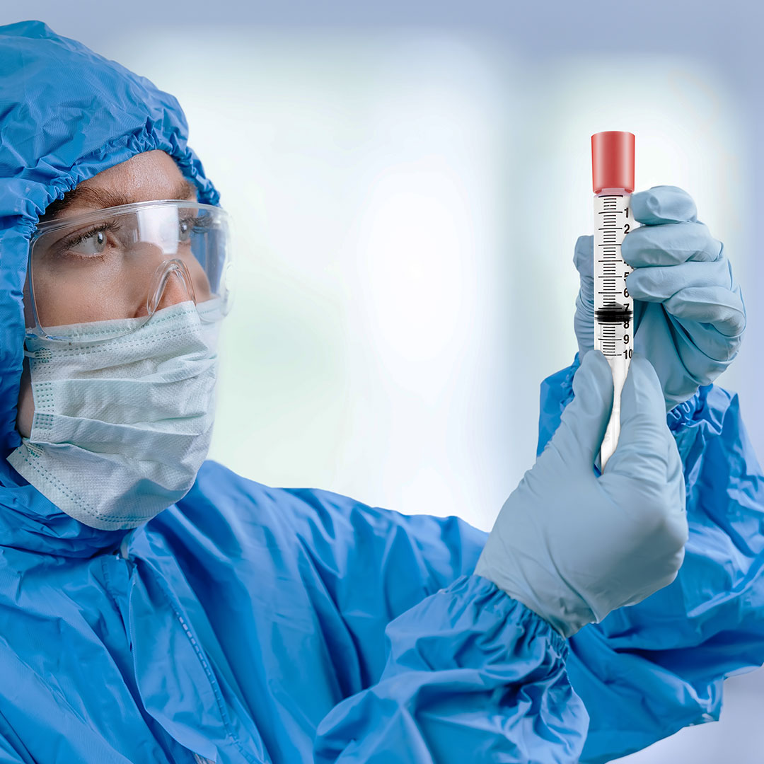 medic-in-hazmat-protective-suit-holds-a-test-tube-2025-03-28-1080x1080 medic holds iv syringe with imi tamper evident cap