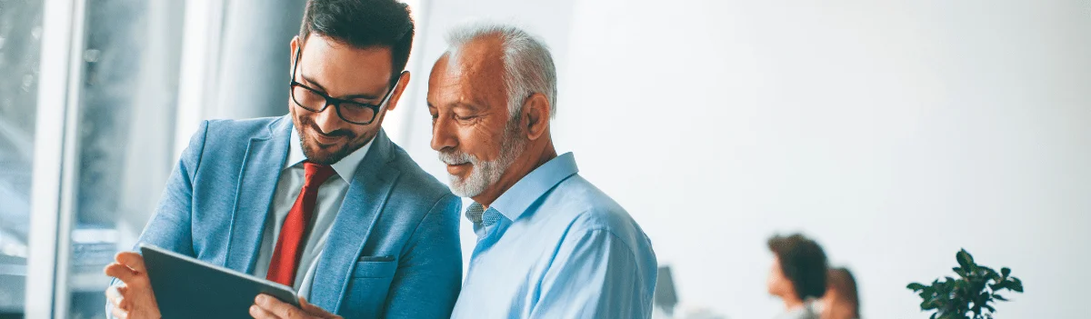 Image of two person looking at a tablet | Advivo