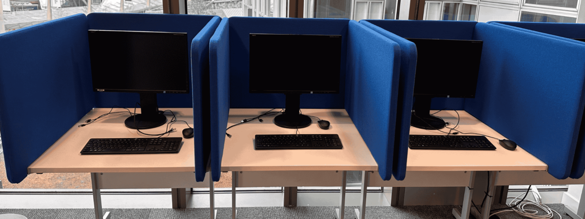 Three computers side by side with dividers