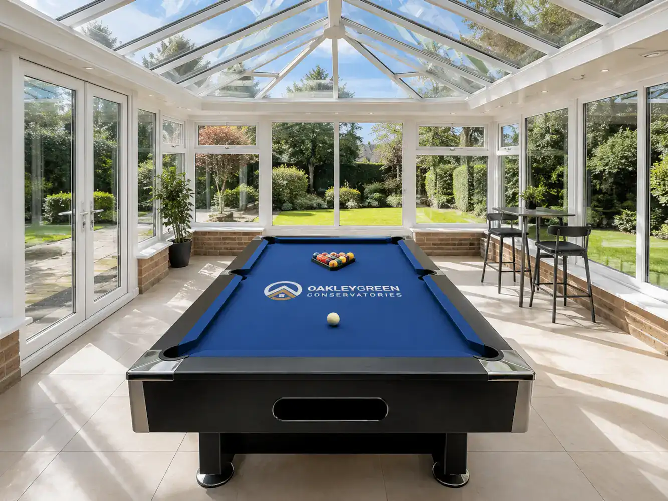 Pool Table conservatory with a blue branded pool table in a bright modern glazed games room by Oakley Green Conservatories.