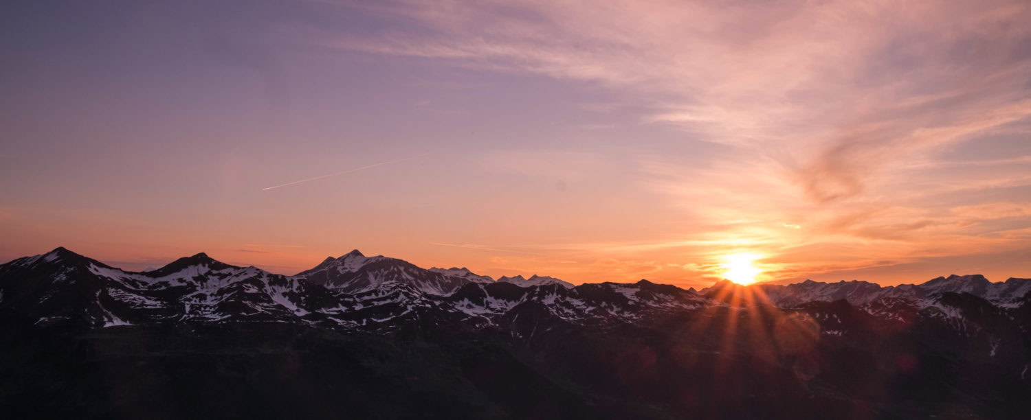 Sonnenaufgang vor schneebedeckter Bergkette am Passo di Leit