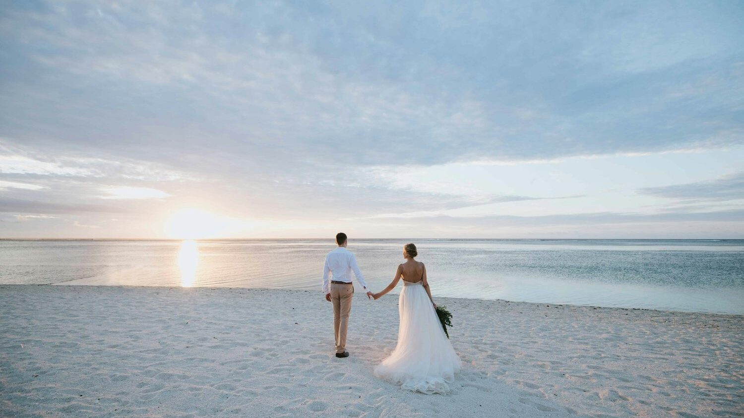 Bride and groom walking on beach, romantic sunset wedding, beach wedding inspiration, newlyweds in love, Hampshire Wedding Photographer Portfolio