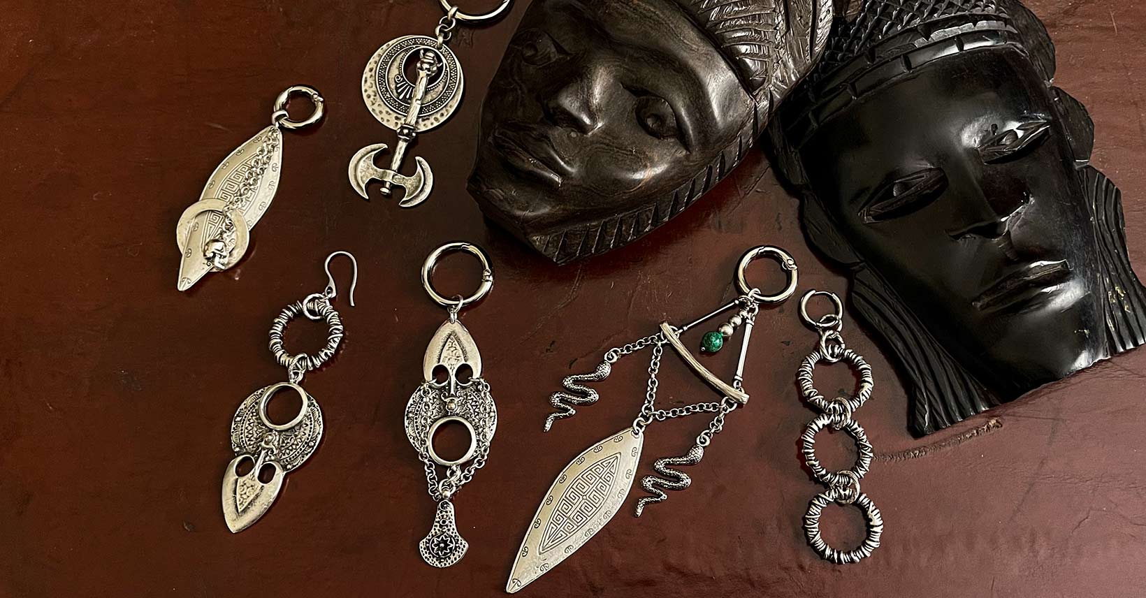 Ear weights, several examples of new designs for large earrings among two tribal masks.