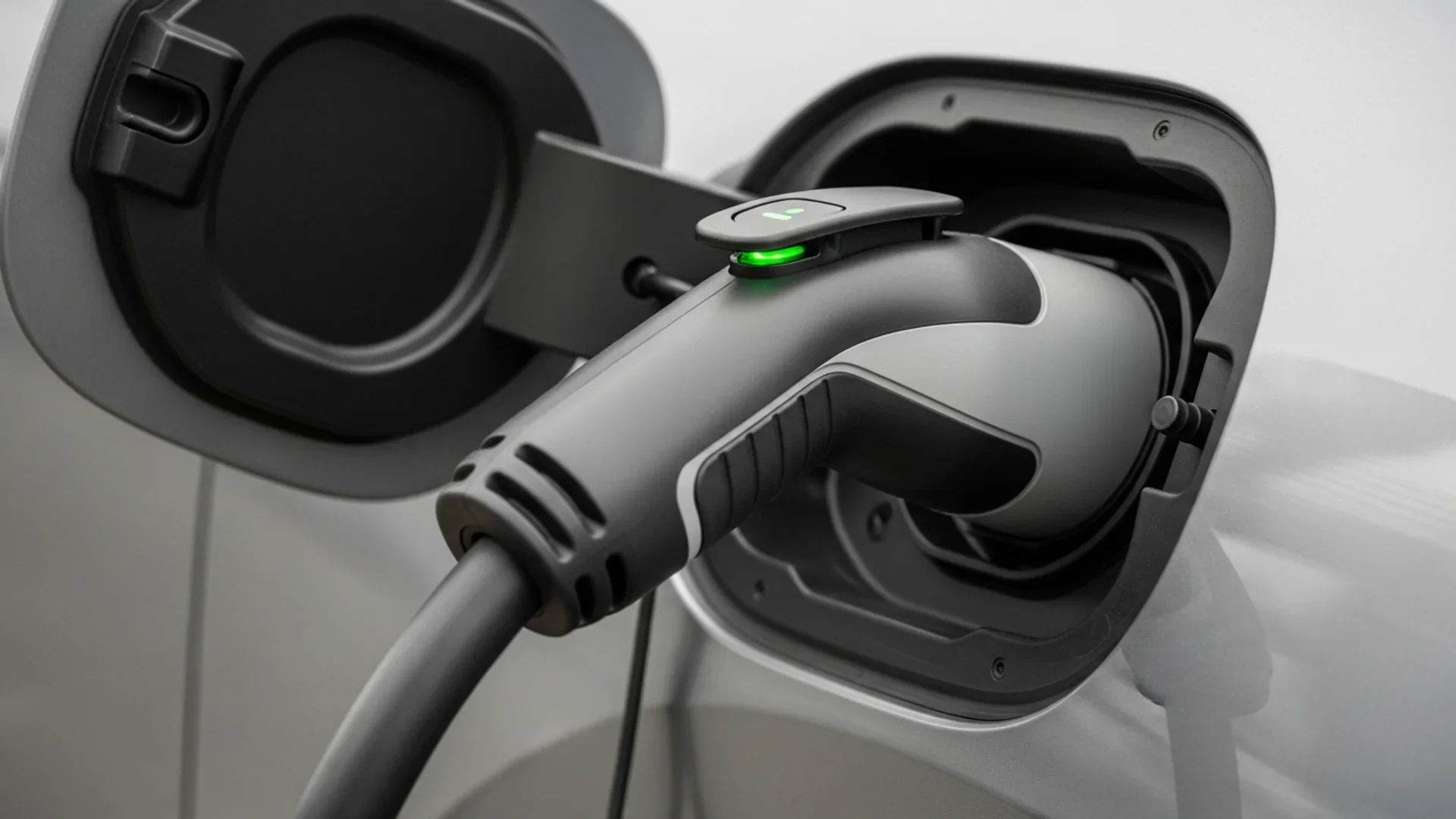 EV charging cable plugged into a modern electric vehicle's charge port.