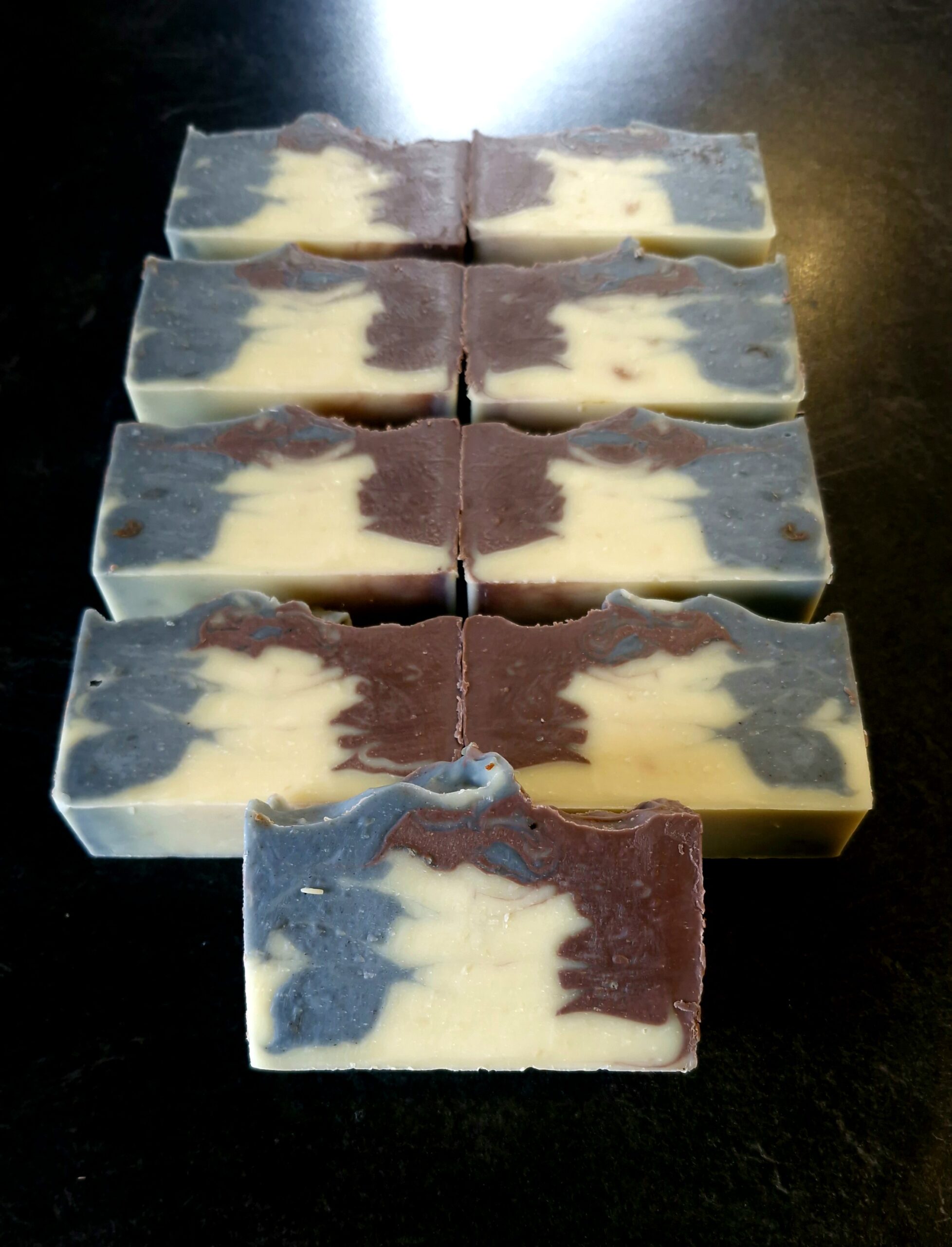 Sliced tallow soap bars with indigo, natural ivory and purple clay swirls, scented with vanilla, amber, musk and sandalwood