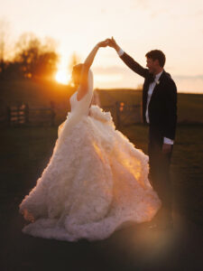 A twirl at sunset making the brides dress glow in the evening light. Taken at Hyde House near Stow-On-The-Wold