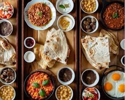 مائدة طعام إماراتية تقليدية في أحد مطاعم دبي الشعبية تبرز كرم الضيافة والأطباق التراثية.